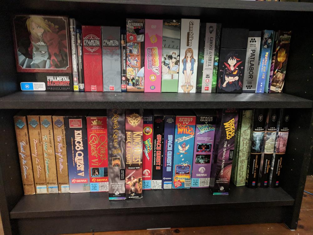 Shelf of anime DVDs and Blu-rays and game boxes and books