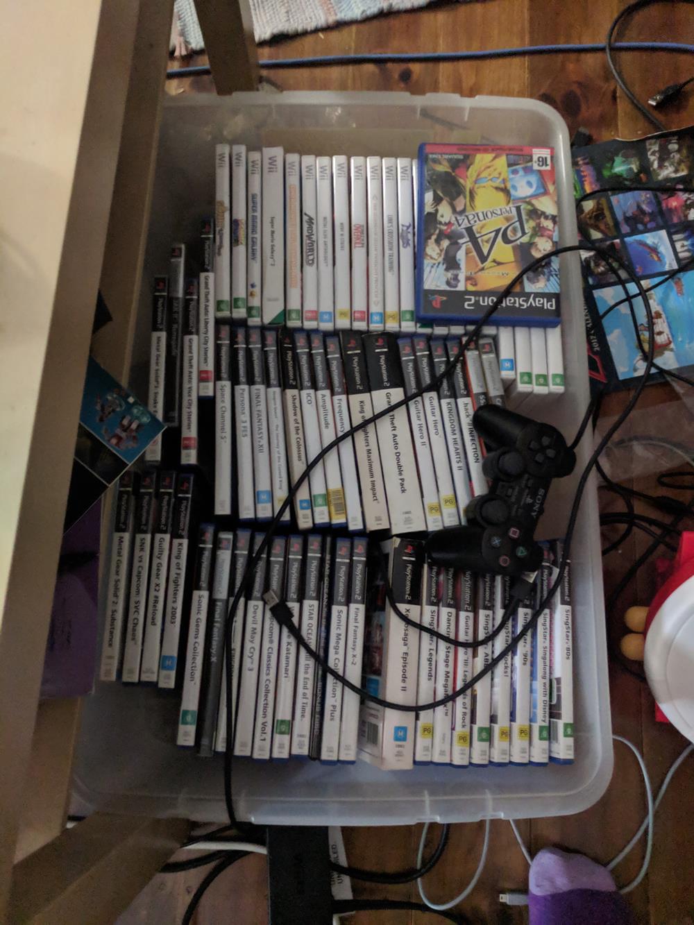 Box full of PS2 and Wii games